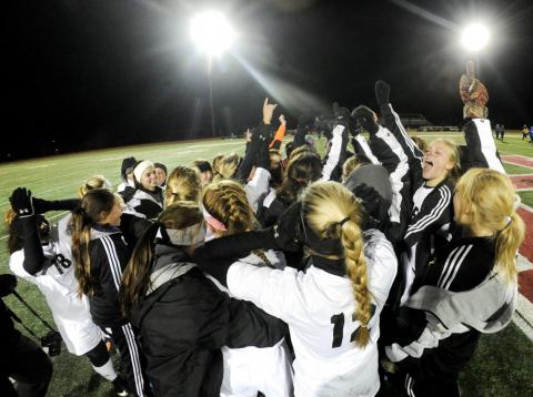 The members of Southern Columbia's girls soccer team celebrate on the field after beating Tulpehocken in Tuesday night’s PIAA State Semifinal game in Hamburg.