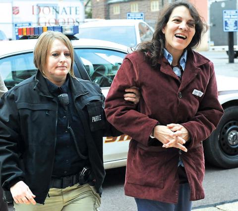Maria Sanutti-Spencer, right, is taken into the Columbia County Courthouse Friday morning by parole officer Vanessa Adler. Sanutti-Spencer was sentenced to life plus 54 years for the killing of Frank Spencer.