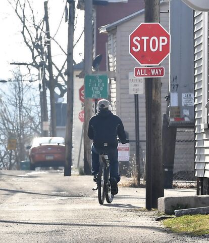 A bicyclist rides along West Pine Avenue in Bloomsburg on Thursday afternoon. Town officials are considering an ordinance that updates bike laws, helmet requirements, electric bicycle use and more.