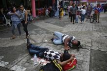 Central American migrants making their way to the U.S. in a large caravan rest lying at the central park in Tapachula, Mexico, Sunday, Oct. 21, 2018. Despite Mexican efforts to stop them at the Guatemala-Mexico border, about 5,000 Central American migrants resumed their advance toward the U.S. border Sunday in southern Mexico. (AP Photo/Moises Castillo)