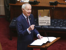 FILE - In this April 8, 2020 photo, Arkansas Gov. Asa Hutchinson gives the State of the State in the senate chamber of the state Capitol in Little Rock, Ark. Hutchinson vetoed legislation that would have made his state the first to ban gender confirming treatments for transgender youth. (Tommy Metthe/Arkansas Democrat-Gazette via AP, File)