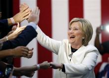 Democratic presidential candidate Hillary Clinton reacts to supporters as she arrives to address supporters at her Super Tuesday election night rally in Miami, Tuesday, March 1, 2016. (AP Photo/Gerald Herbert)