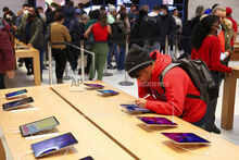 A person shops in an Apple store on Black Friday, Nov. 25, 2022, in New York. (AP Photo/Julia Nikhinson)