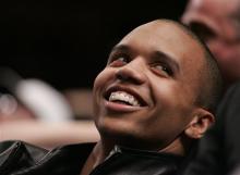 This is a Tuesday, March 21, 2006 file photo of professional poker player Phil Ivey as he relaxes during a timeout in the third quarter of NBA basketball action between the New York Knicks and the Toronto Raptors at Madison Square Garden in New York. A casino group has accused U.S. professional poker star Phil Ivey of cheating at baccarat and says the alleged scam means they don't have to pay his claimed multimillion dollar winnings. The Genting Group said in court papers filed Tuesday May 14, 2013 t