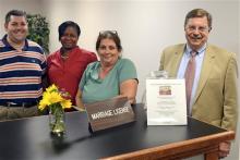 In this July 31, 2013 photo, Montgomery County Register of Wills Bruce Hanes, right, poses at the marriage license and certificates desk with some of his staff, clerks Drew Albert, left, and Lisa Wayne, second from left, and second deputy registrar Helene Sepulveda in Norristown, Pa. The mild-mannered Montgomery County register of wills went out on a limb July 24 when he began issuing same-sex marriage licenses in violation of state law. (AP Photo/The Philadelphia Inquirer, Tom Gralish)