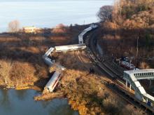 Cars from a Metro-North passenger train are scattered after the train derailed in the Bronx borough of New York, Sunday, Dec. 1, 2013. The Fire Department of New York says there are "multiple injuries" in the train derailment, and 130 firefighters are on the scene. Metropolitan Transportation Authority police say the train derailed near the Spuyten Duyvil station. (AP Photo/Edwin Valero)