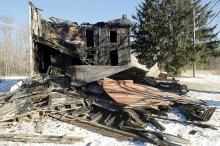 The remains of a home destroyed by fire sit on a lot in the area of 322 Goss Road in Fairmont Township after an early morning fire Wednesday which has been ruled arson. (Press Enterprise/Jimmy May)