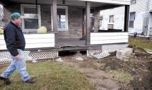 Bruce Leckie surveys the damage to the front porch of his home at 1329 West Front Street in Berwick after a U-Haul box truck crashed into the house on Friday morning. (Press Enterprise/Bill Hughes)