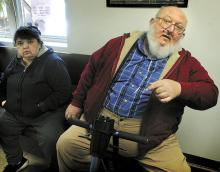 Carl Eugene Wolfgang, 56, Numidia, sits in his motorized wheelchair, on Thursday, while waiting to go before District Judge Craig Long in Catawissa on charges that he groped an 18-year-old home health aide. At left is his wife, Diane Wolfgang. (Press Enterprise/Bill Hughes)