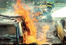 Firefighters battle a blaze at 127 First Ave. in Briar Creek Sunday afternoon as flames pour from the gasoline tank on this minivan in the driveway of the home. (Press Enterprise/Keith Haupt)