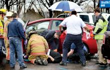 Rescue workers tend to a woman who was caught under her Toyota Prius in the parking lot at Geisinger Medical Center in Danville on Wednesday. (Press Enterprise/Bill Hughes)