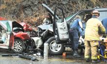 Emergency crews work to remove the female driver of this Ford Expedition after a head-on collision with a Subaru near Three Points intersection in Catawissa Township Tuesday afternoon. (Press Enterprise/Keith Haupt)