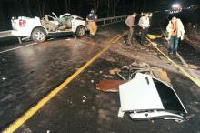 Catawissa Borough Chief of Police Joshua Laidacker, right, documents the scene of a two vehicle crash on Southern Drive in Franklin Township which left two people dead late Wednesday night. Two others had to be extricated from the Ford Escape and were taken to Geisinger Medical Center. (Press Enterprise/Jimmy May)