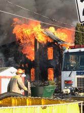 A fire rages on Colley Street on Tuesday afternoon. (Press Enterprise/Michael Lester)