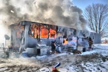 A firefighter battles a blaze at 46 Oriole Road, Greenwood Township. (Special to the Press Enterprise/Harry Watts)