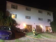 Firefighters doused a fire in the garage bays below apartments at 223 Lockard Ave. Thursday. (Press Enterprise/M.J. Mahon)