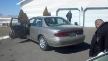 Police examine the car that rolled over Mary Ellen Keough's leg. (Press Enterprise/Leon Bogdan)