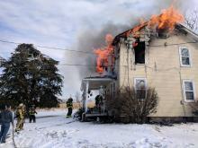 Flames burn on the second floor of a house off Haskell Lane in Mifflin Township on Friday afternoon. (Press Enterprise/Jimmy May)