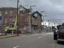 Bob and Trinell Bull look on as demolition begins on a building they own at 102-106 E. Second St., Berwick. (Press Enterprise/Jimmy May)