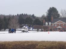 A patient is taken to the LifeFlight helicopter, which landed near a one-vehicle wreck on Martzville Road. (Press Enterprise/Kristin Baver)