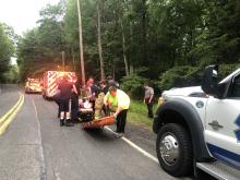 Susan Schwartz/Press Enterprise Rescuers prepare Sandra Koffel to be loaded into a Shickshinny Ambulance after carrying her out of the woods by Shickshinny Falls.