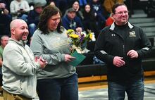 Press Enterprise/Jimmy May Southern Columbia wrestling coach Stephan Pesarchick, left, stands on the mat with Colleen and Kent Lane before the meet against Montoursville Thursday night as the couple were honored for their contributions to the school’s wrestling program.