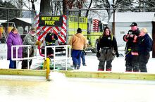 Berwick firefighters use tankers to fill the new ice skating rink on the tennis courts in Ber-Vaughn Park on Saturday morning. The rink, assembled Thursday and Friday by the Berwick borough public works crew. has a white plastic liner with a wooden curb around. An estimated 12,000 gallons of water were required to fill the rink.