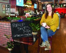 Kim Kus sits in the entrance of her business Brewskis on Main Street in Bloomsburg. The business host several pop ups during each First Friday. 