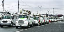 About 60 electric utility trucks from Haugland Energy Group and I.B. Abel Utilities stage as a storm response team at the request of PPL Electric Utilities on the Bloomsburg Fairgrounds on Sunday afternoon. 