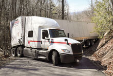 The driver of an U.S. Xpress tractor trailer jackknifed his rig while trying to back down Overlook Road in Nescopeck Township Monday afternoon after realizing he could not get around the hairpin turn just up the hill from Ridge Road.