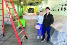 Press Enterprise/Jimmy May Ding Tea owners Ai Nguyen and Vinh Ton stand in their business Monday along West Main Street in Bloomsburg while waiting for cleaning to be done following last week’s fire in a connecting business. 