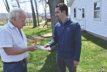 State Representative Robert Leadbeter, right, talks with Mark Ehmann outside of the Fishing Creek polling place at the St. James Community Hall along Zaner Bridge Road Tuesday afternoon. 