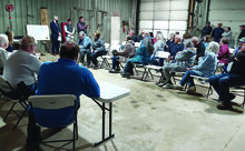 Greenwood Township supervisors, at left, listen along with a crowd of citizens as details of proposed solar farm are explained at a hearing Tuesday night.