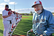 Bloomsburg’s former baseball coach John F. Babb stands on the field which has been named after as the team takes to the third base line before the start of Wednesday evening’s game against Warrior Run. 