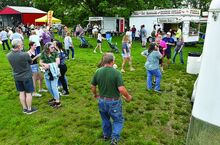 People line up in front of food venders ringing the Mifflinville Carnival Grounds Thursday evening along East First Street in Mifflinville. The carnival runs through Sunday with live music each night and a tractor show Saturday and Sunday. 