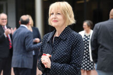 Bloomsburg University board of trustees chairwoman Judge Mary Jane Bowes, walks away with a section of ribbon from the ribbon-cutting ceremony for the $34.9 million Arts and Administration Building on Wednesday afternoon. The structure consists of four floors with wood and metal shops; theatre and photo labs; and a student studio and plaster room.