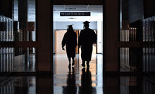 Danville seniors Lyla Lewczyk, left, and Brady Hill walk through the hall of Danville High School Friday evening for one of the last times before their graduation ceremony. 