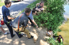 Members of the Bloomsburg Fire Department assist Bloomsburg Ambulance with getting a 16-year-old from Fishing Creek Wednesday afternoon after he injured his knee while swimming at the rope swing across from the Bloomsburg Fairground parking lot along West Fort McClure Boulevard. 