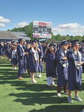 Central Columbia graduates line up in Blue Jay Stadium prior to Saturday morning commencement ceremony.  