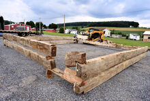 A crew with Dolittle Construction lays out logs from an 18th century log cabin in a parking area on the Montour-DeLong Fairgrounds on Thursday. 