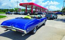 Press Enterprise/Geri Gibbons Jamie Cerasoli and his mother Sharon wait to get gas on Tuesday morning at Sheetz in Briar Creek in their 1968 Buick Skylark. The two said that the reduced cost of $1.77 per gallon was well worth the wait.