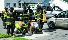 Berwick Firefighters help with cleanup after a car was flipped in an accident Saturday afternoon on walnut Street in Berwick, they collect the items that fell out of the flipped car and spread quick-dry over the liquids that came from the vehicle.