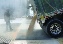 Chris Kitchen, operations manager for the Boyd Station, unloads about 1,000 bushels of soybeans into the new conveyor belt on Tuesday.