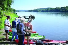 The residents of Maria Joseph Continuing Care Community in Danville get life vests on and prepare to get into kayaks at the Shady Nook Boat Access in Selinsgrove. The group boated 3 miles down the Susquehanna River on Friday.