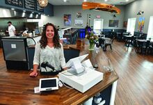 Jenn Kurian, co-owner of Wild for Salmon, standing in the new cafe area which they have added along with expanding their market at the Montour Township business. 