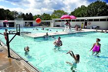 Bathers play basketball and engage in various other activities in the cooling water in Bloomsburg’s recently reconstructed Norris E. Rock Memorial Pool on Sunday. 