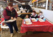 Press Enterprise/Jimmy May Having some eggs and bacon for breakfast in the Cattle Barn after taking care of the animals are from left, Marsha Eckrote, Carlee Snyder, 2, Blaire Eckrote and Madelyn Snyder, 9, Saturday morning at the Bloomsburg Fair. 