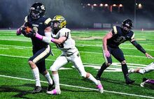 Southern Columbia defender Jake Toczylousky intercepts a pass intended for Wyoming Area's Dominic Colavito and runs the ball back into the end zone for a touchdown at Tiger Stadium on Friday night. Southern won 55-28.