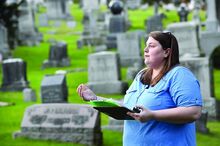 Author  Rachel Shaffer talks about one of the graves in the Rosemont Cemetery Friday evening while doing a walk through the cemetery.