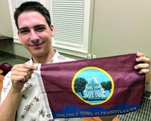 Ayden Pointer, 18, displays a flag he presented to Bloomsburg Town Council. Pointer said the town has no official flag; he is hoping to change that.